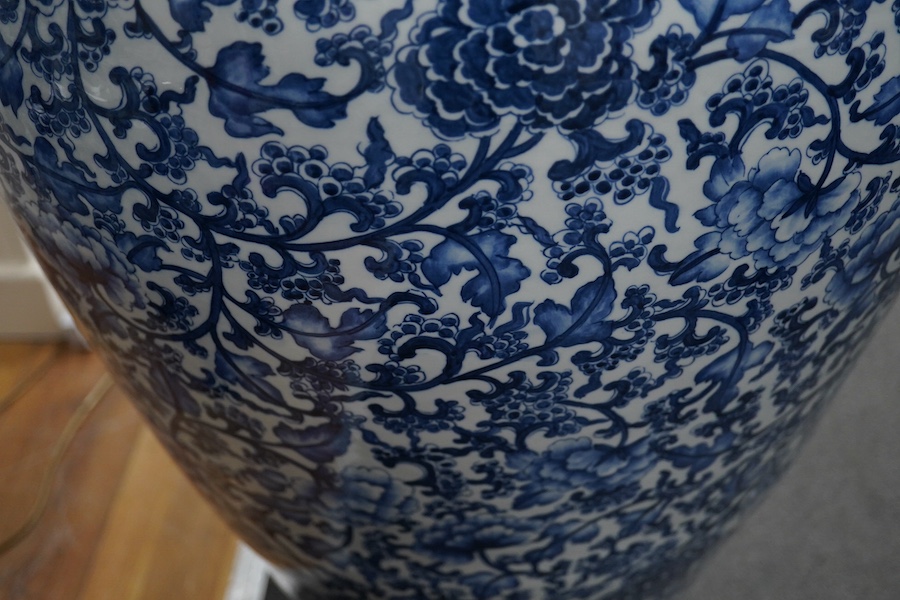 A massive Chinese blue and white floor standing baluster vase, decorated with peonies and foliage, 120cm high. Condition - good